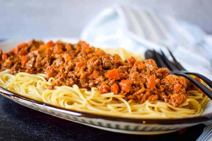 traditional beef ragu over a bed of spaghetti noodles