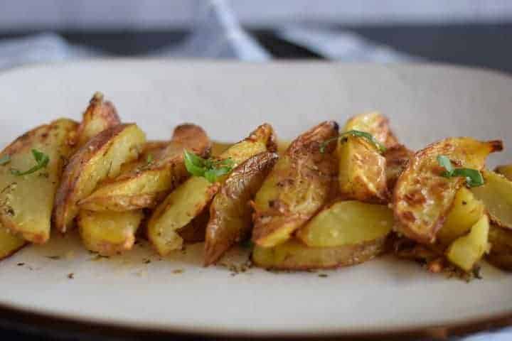 greek air fryer potatoes on white platter