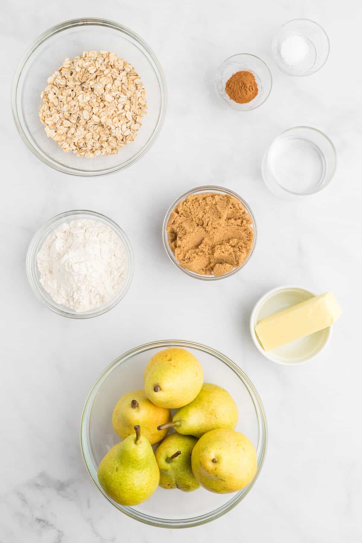 pear crisp ingredients in small glass bowls. 
