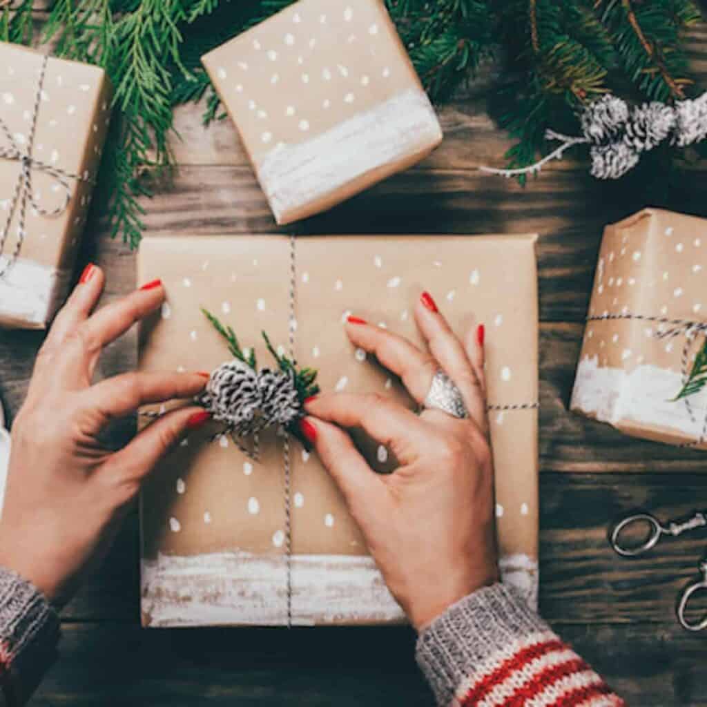 tying a piece of twine around a christmas gift