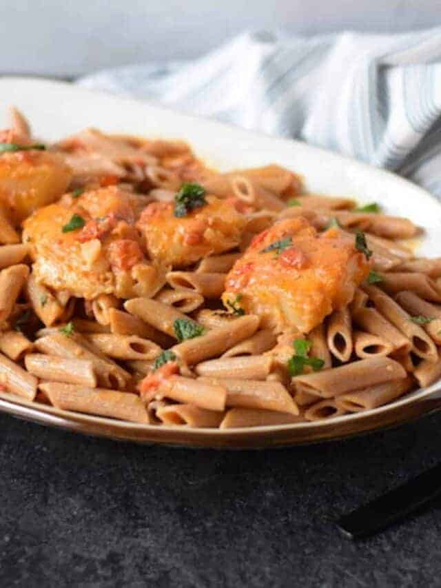 creamy poached cod over pasta on a platter