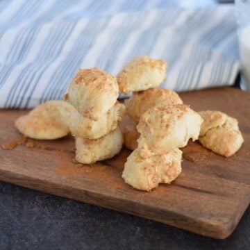 almond scones with honey drizzle on wooden cutting board