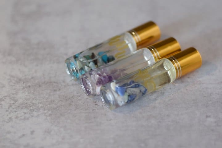 Essential oil roller bottle recipes in clear bottles with gold tops