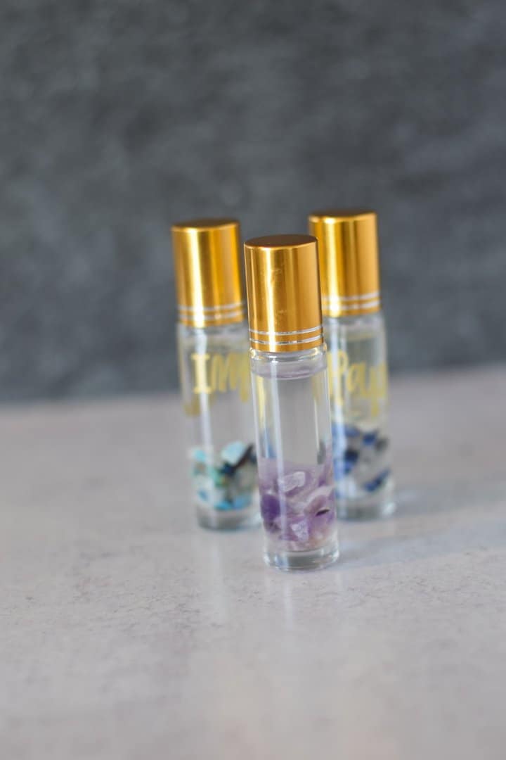 clear essential oil roller bottles with a gold top