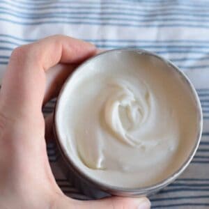 homemade body butter in a metal tin