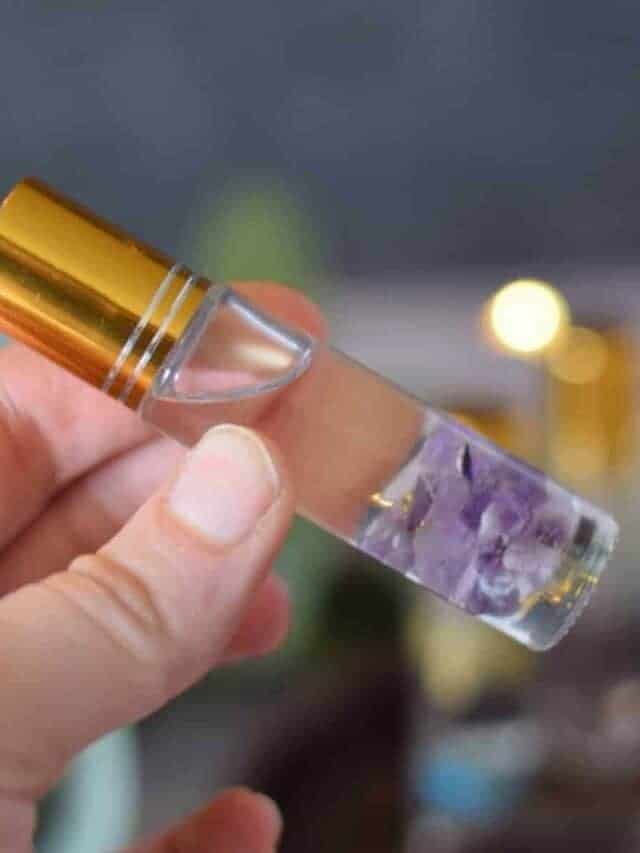 essential oil roller bottle with amethyst rocks