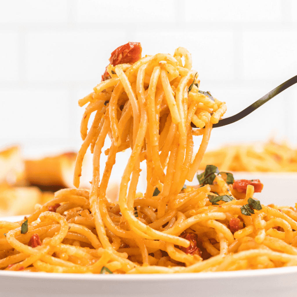 black forkful of sun-dried tomato spaghetti noodles