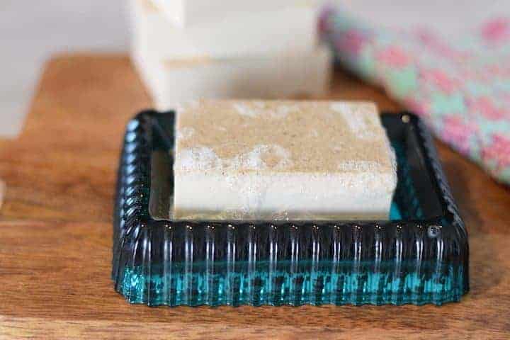 homemade oatmeal soap bar on a blue soap dish