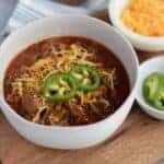 keto chili in a white bowl with garnishes in small bowls