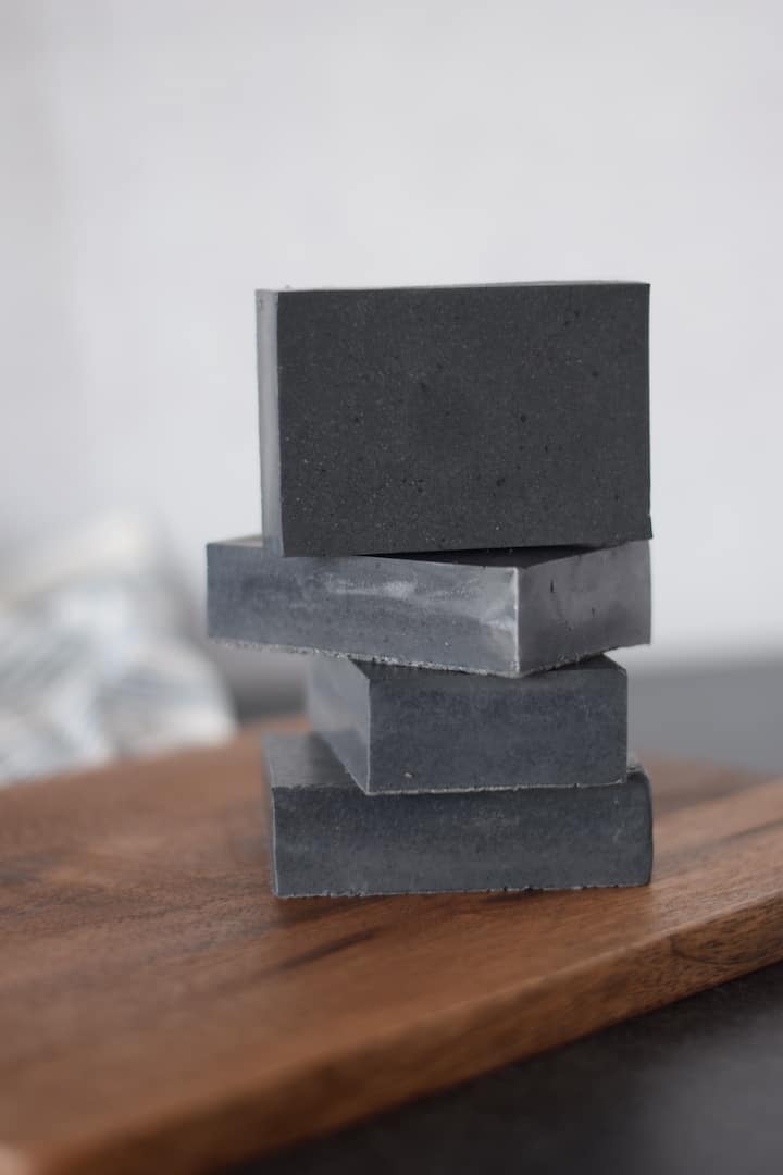 clay and charcoal soap bars stacked on each other