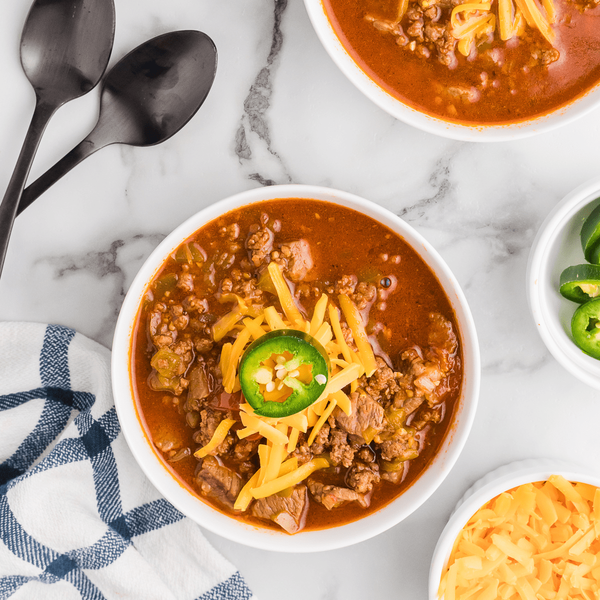 two white bowls of chili.