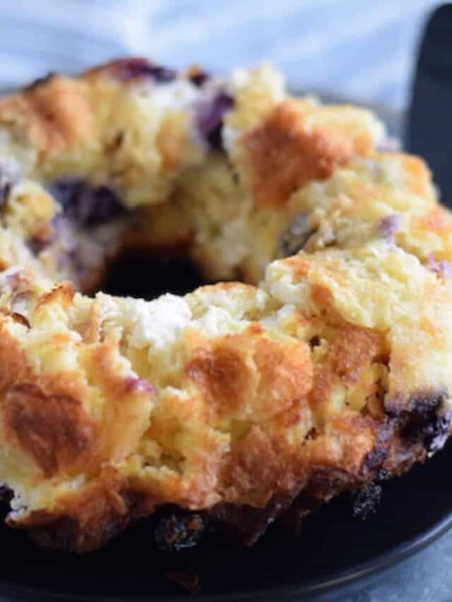 blueberry cream cheese bread pudding on a black plate