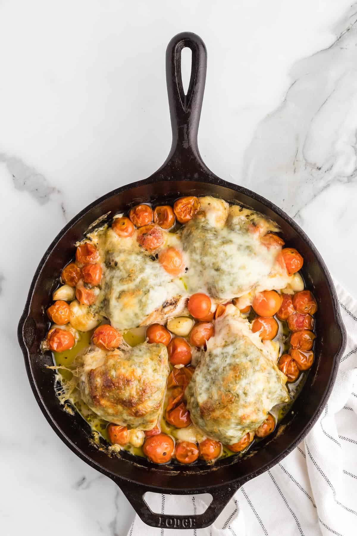cast iron skillet with finished keto caprese chicken