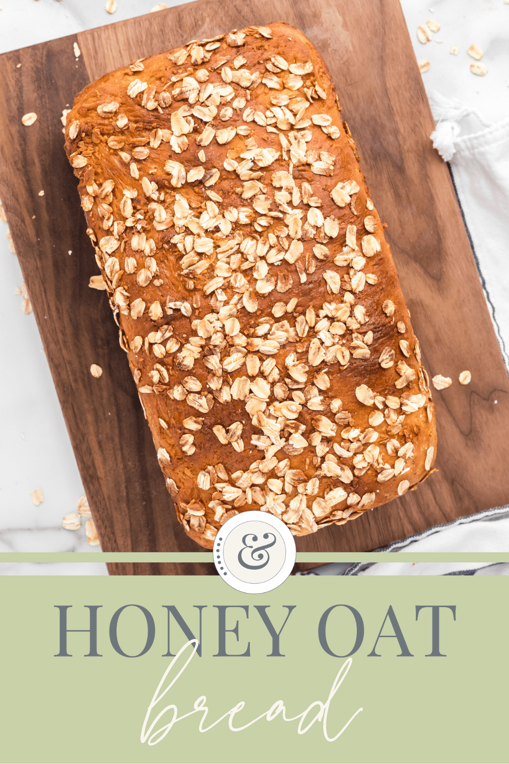 loaf of honey oat bread on a wooden cutting board.