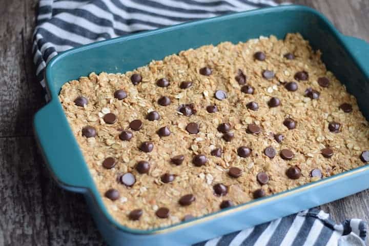 granola bars in a blue baking dish prior to cutting