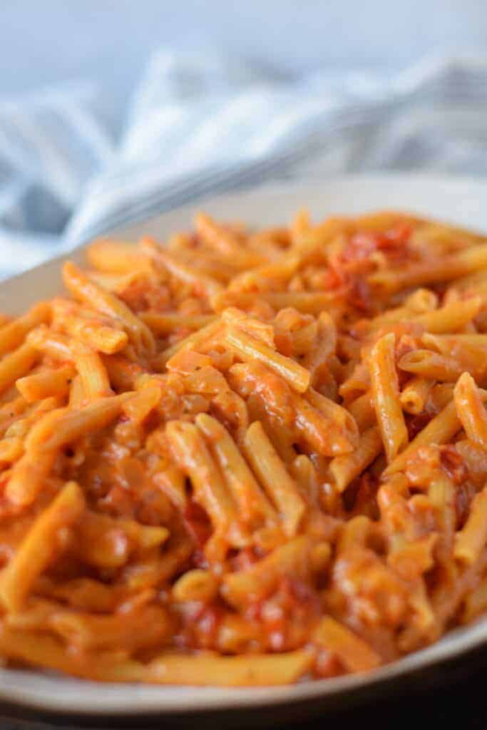close up image of creamy Pomodoro sauce over penne pasta