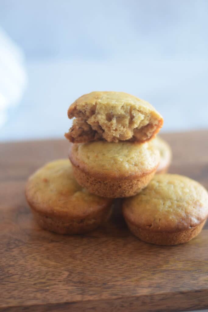 stack of honey banana muffins on a wooden board