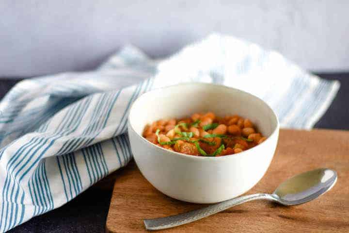 simple greek bean soup in a white bowl