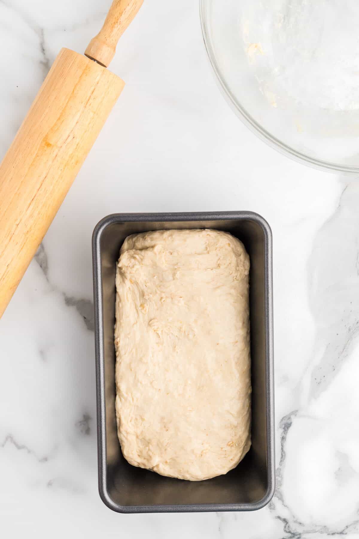 bread dough inside of bread pan. 