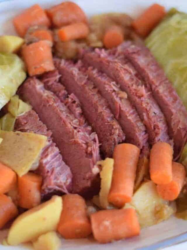 white platter filled with Ninja Foodi corned beef, carrots, cabbage, and potatoes
