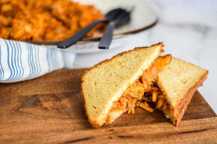 shredded bbq chicken over grainy bread  and cut in half