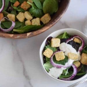 buttermilk ranch dressing on a salad in a white bowl