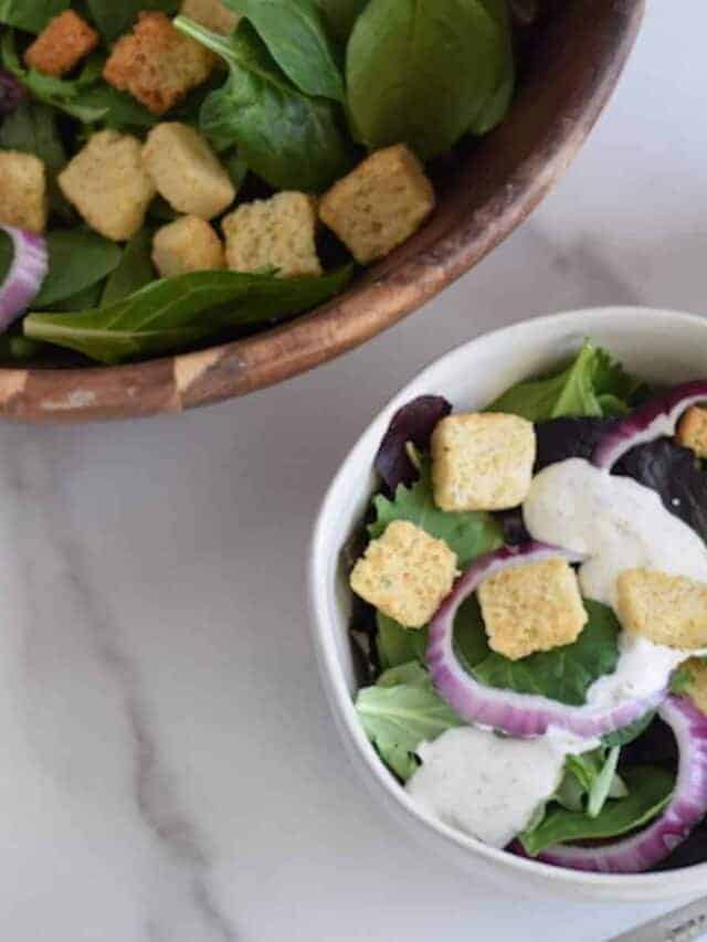 buttermilk ranch dressing on a salad in a white bowl