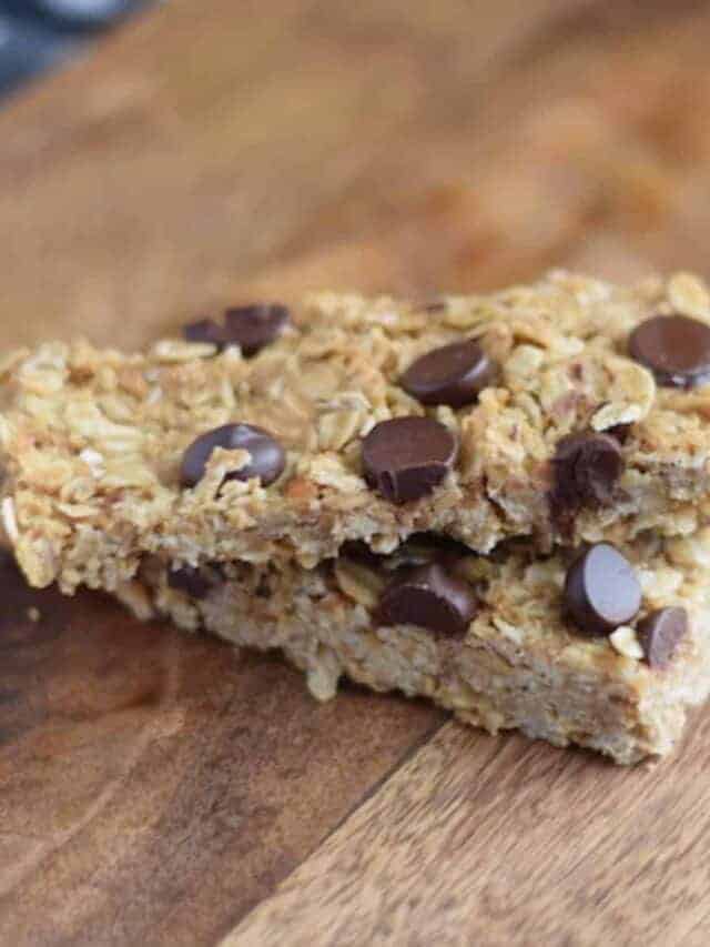 closeup image of granola bars with chocolate chips on a wooden cutting board