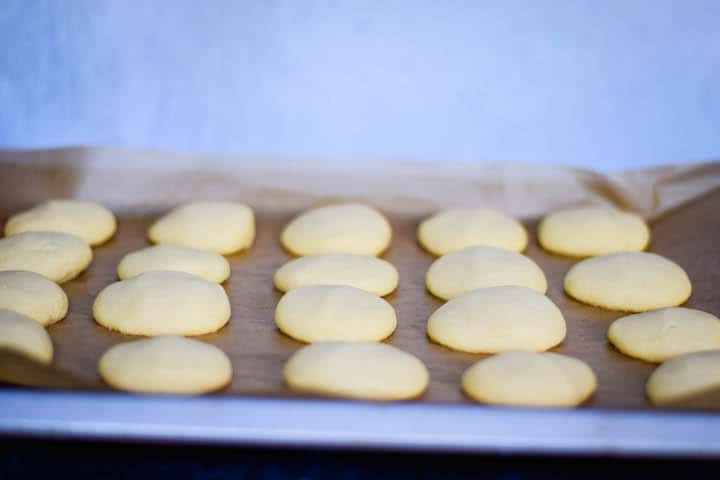 greek butter cookies fresh out of the oven on a cookie sheet