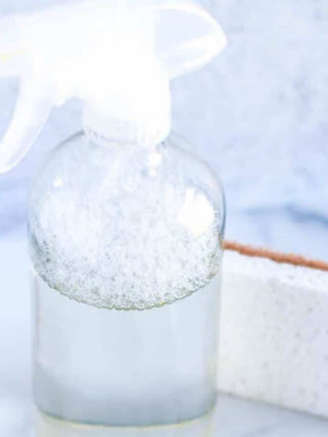 white sponge and clear glass spray bottle with homemade cleaners