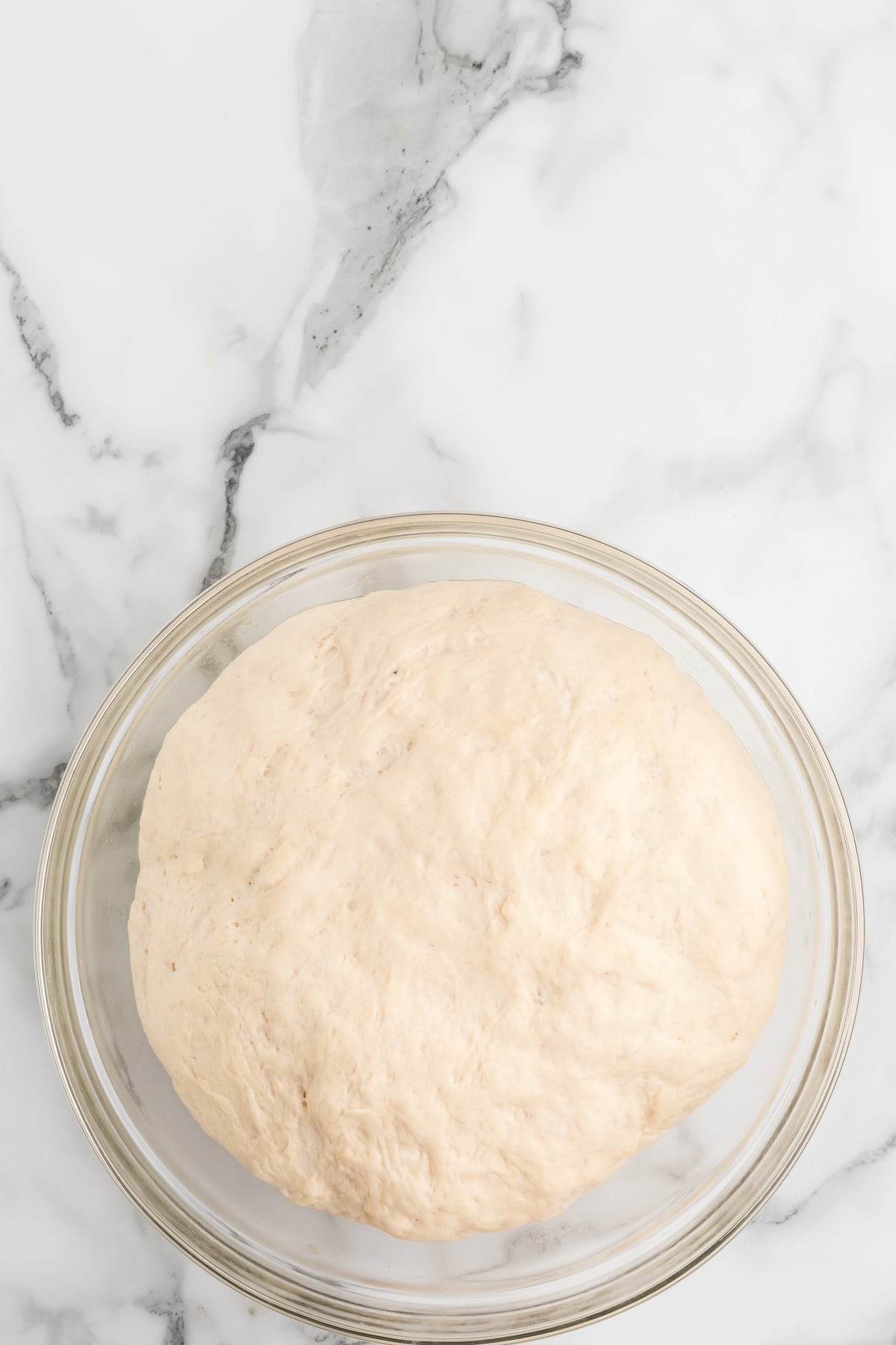 dough after it has risen inside of the bowl.