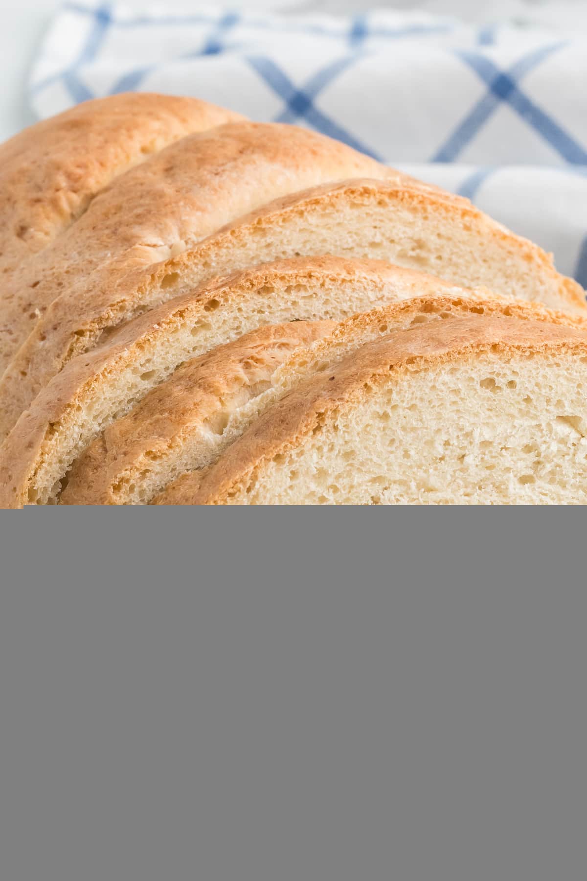 slices of the italian loaf bread on a rustic wooden cutting board.