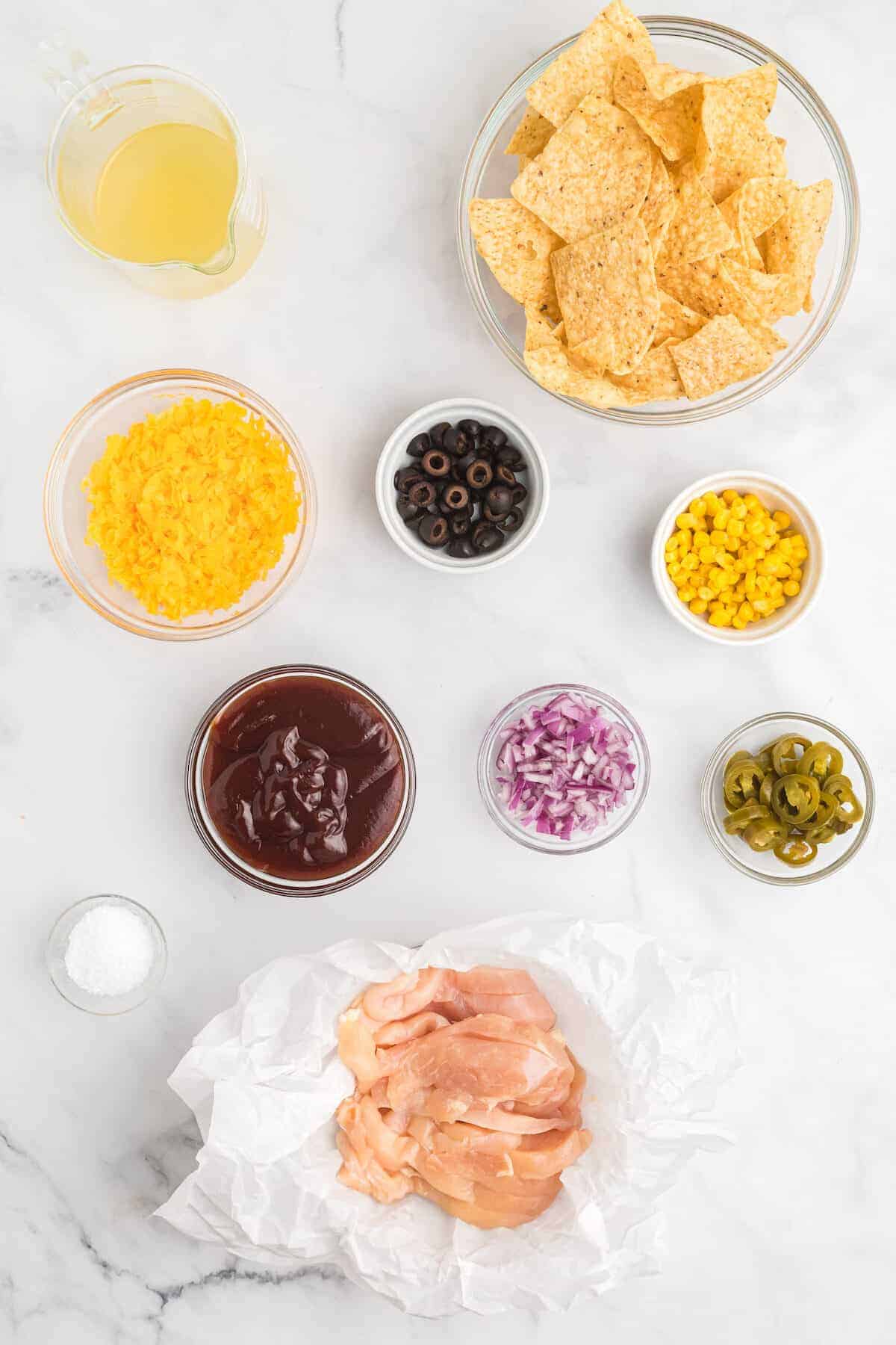 ingredients for the nachos in small bowls 