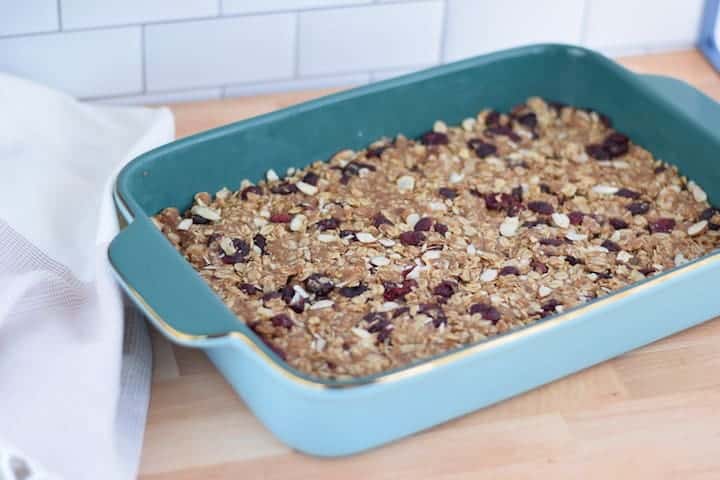 cranberry almond granola bars in a blue baking dish