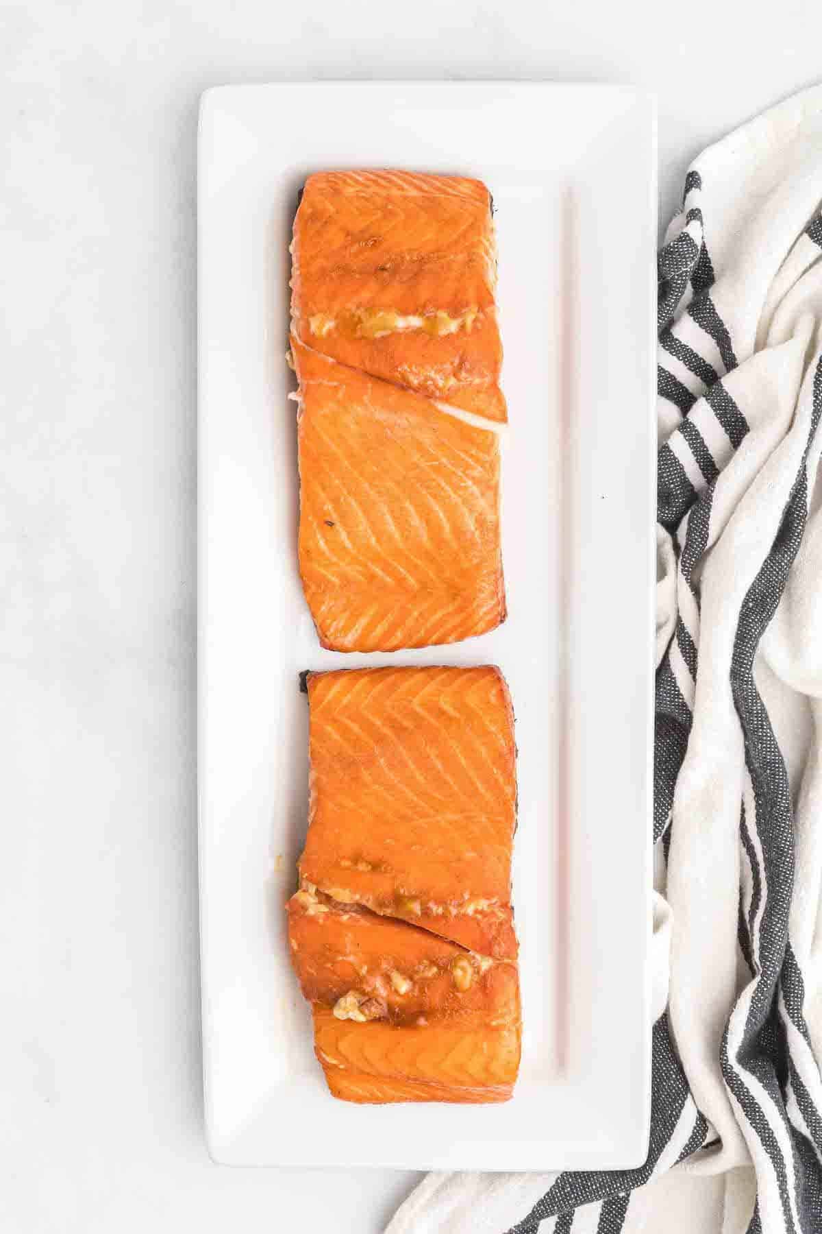 white platter with two salmon pieces.