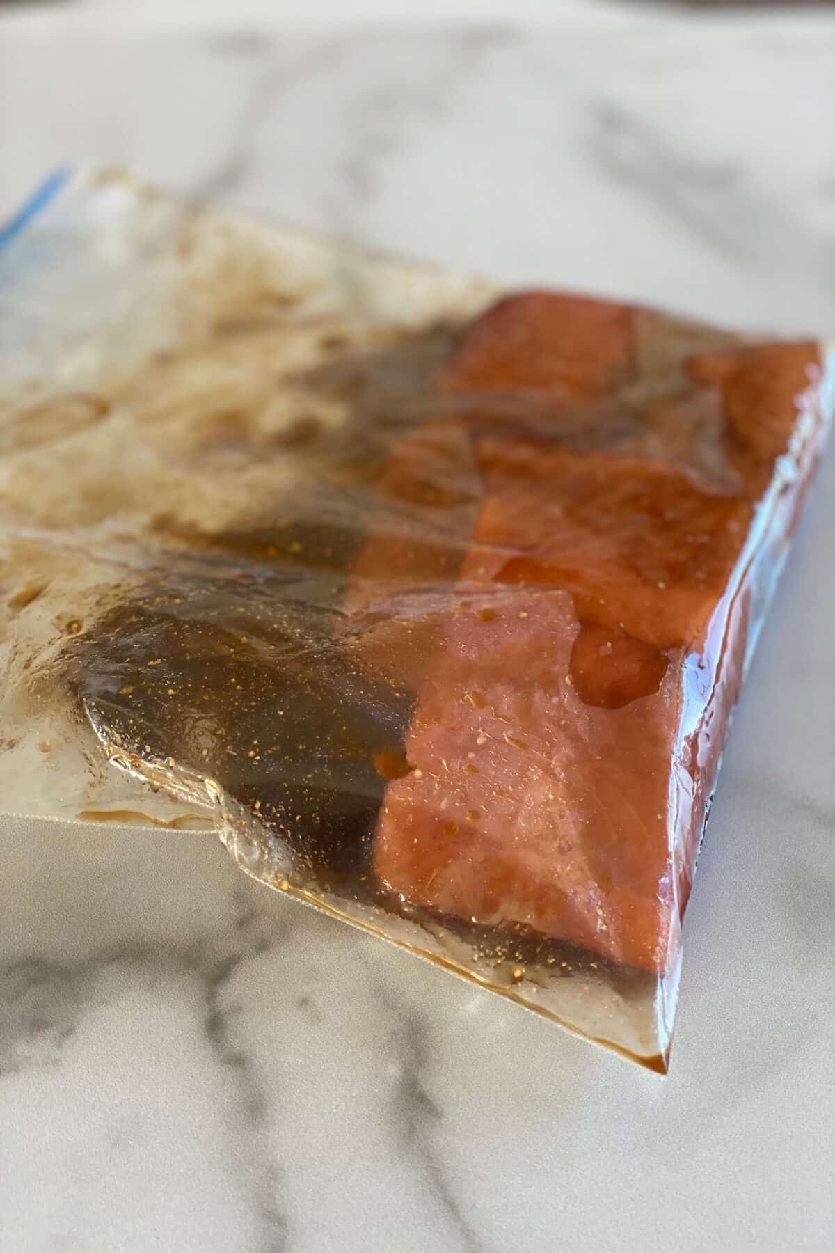 marinating the salmon in a large plastic bag.