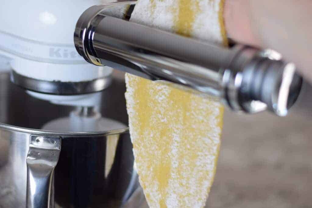 using a pasta roller attachment to roll out pasta on the stand mixer