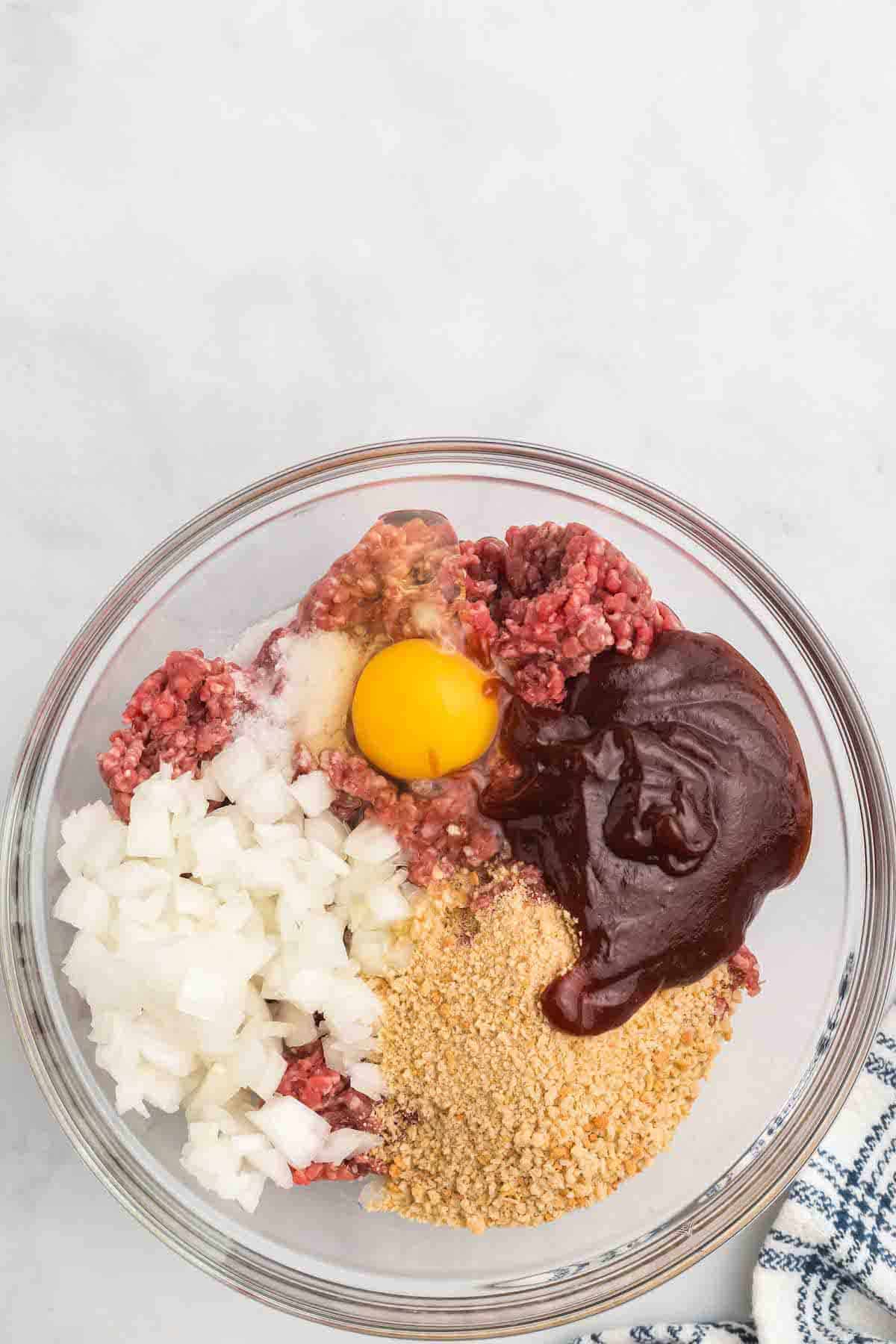 meatloaf ingredients layered in a large bowl
