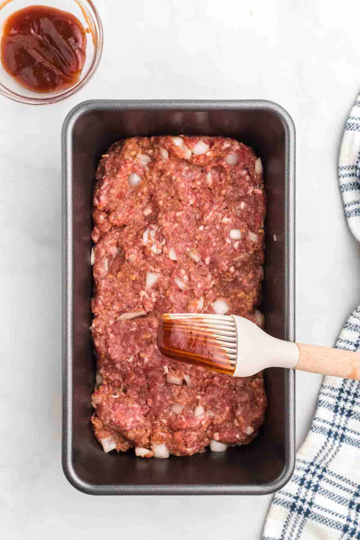 brushing the meat loaf bread with a little bbq sauce