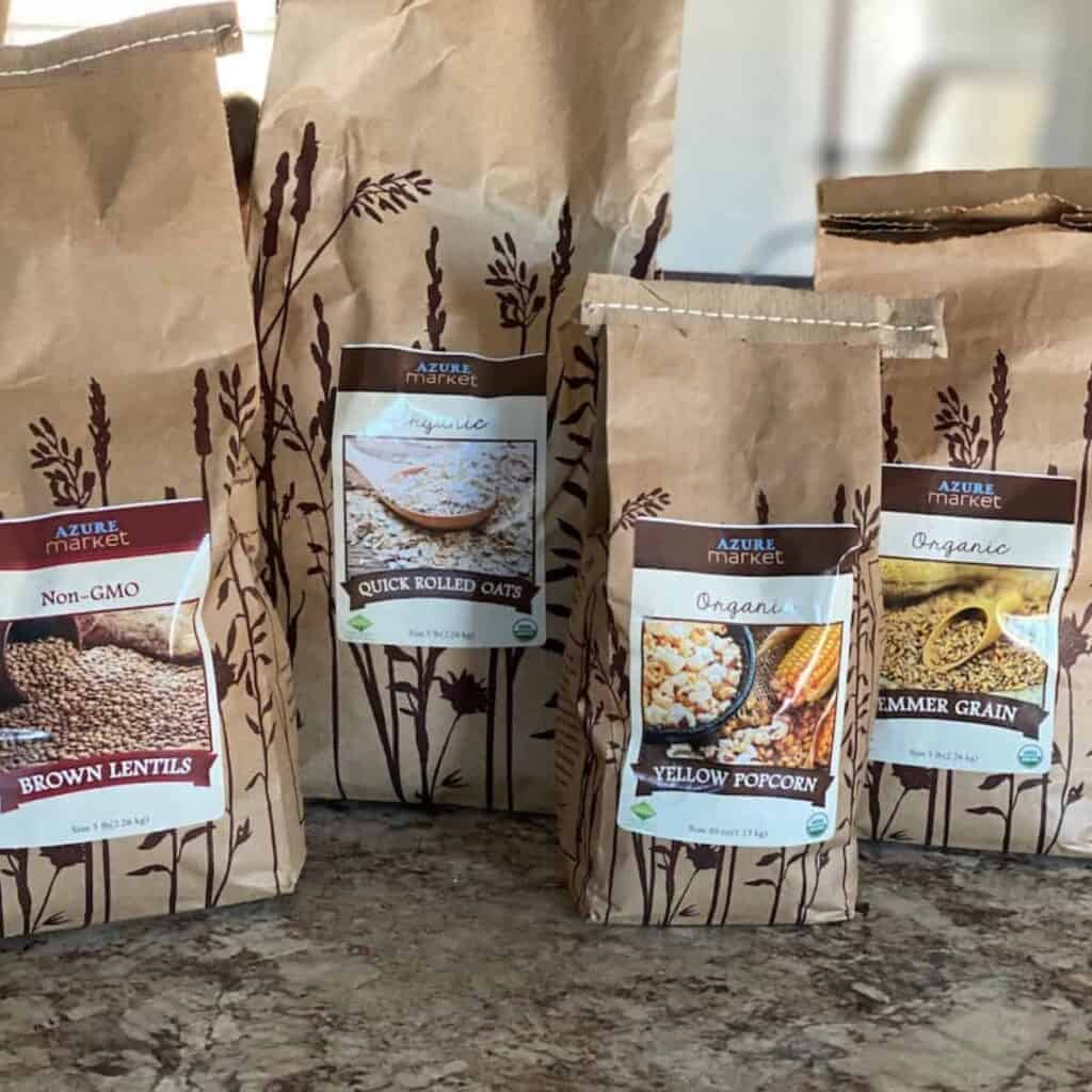 bulk pantry staples of grains and oats in brown paper bags