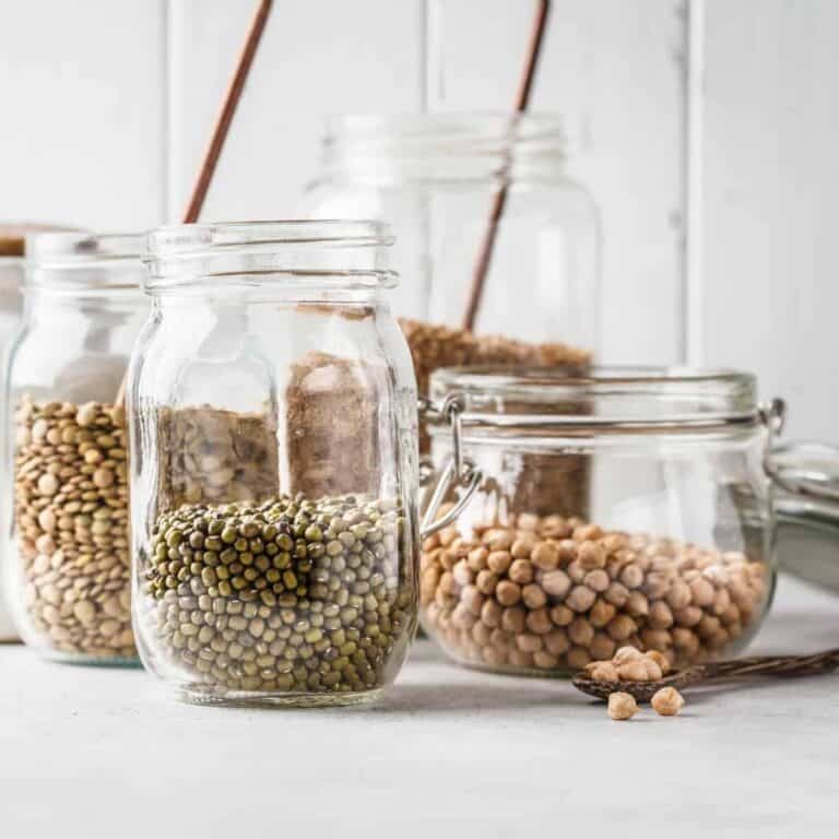 clear mason jars of dried beans on a counter top