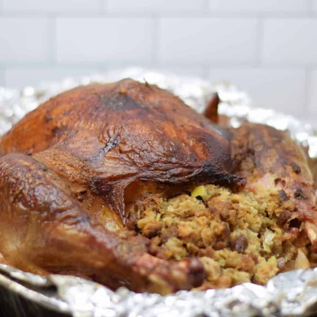 traeger turkey with stuffing in a roasting pan