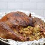 traeger turkey with stuffing in a roasting pan