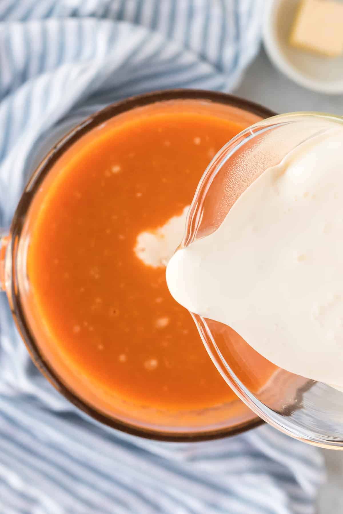 pouring in the heavy cream to the blended soup