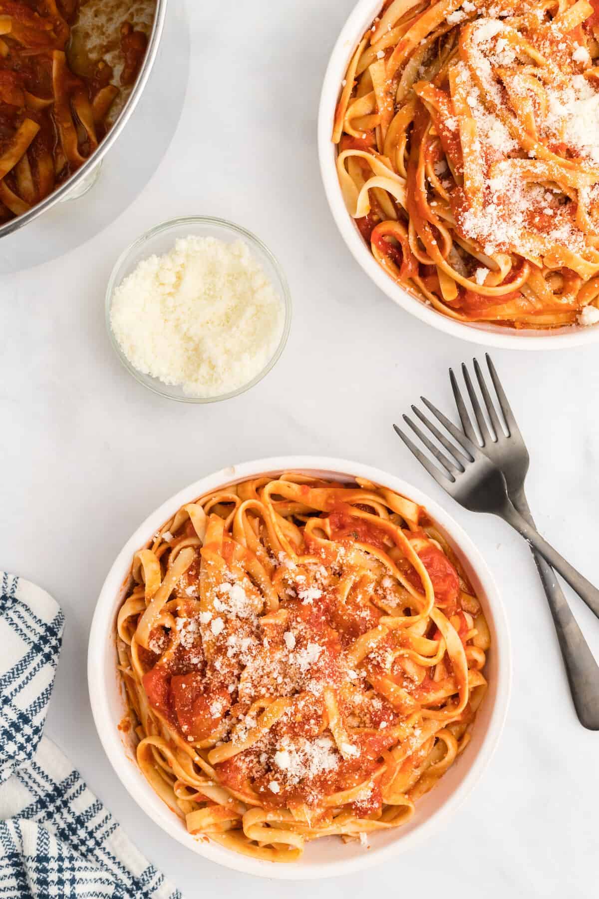 two white bowls of pasta with San Marzano pasta sauce.