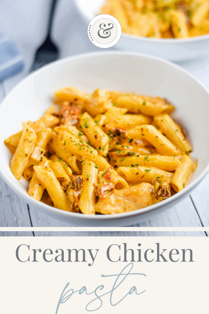 two white bowls of creamy sun dried tomato chicken pasta on a table