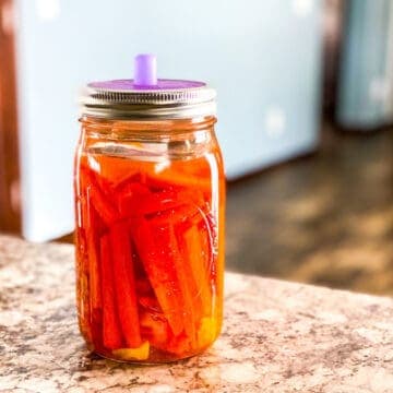 Mason jar of fermented carrots ginger and turmeric