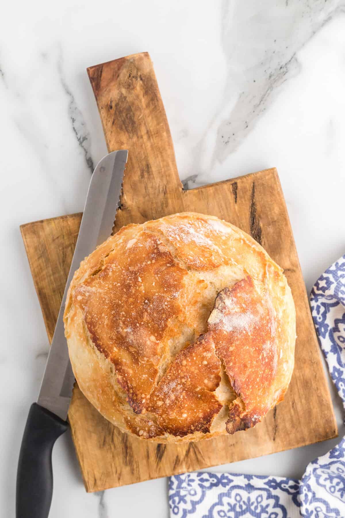 artisan bread loaf on a wooden cutting board.