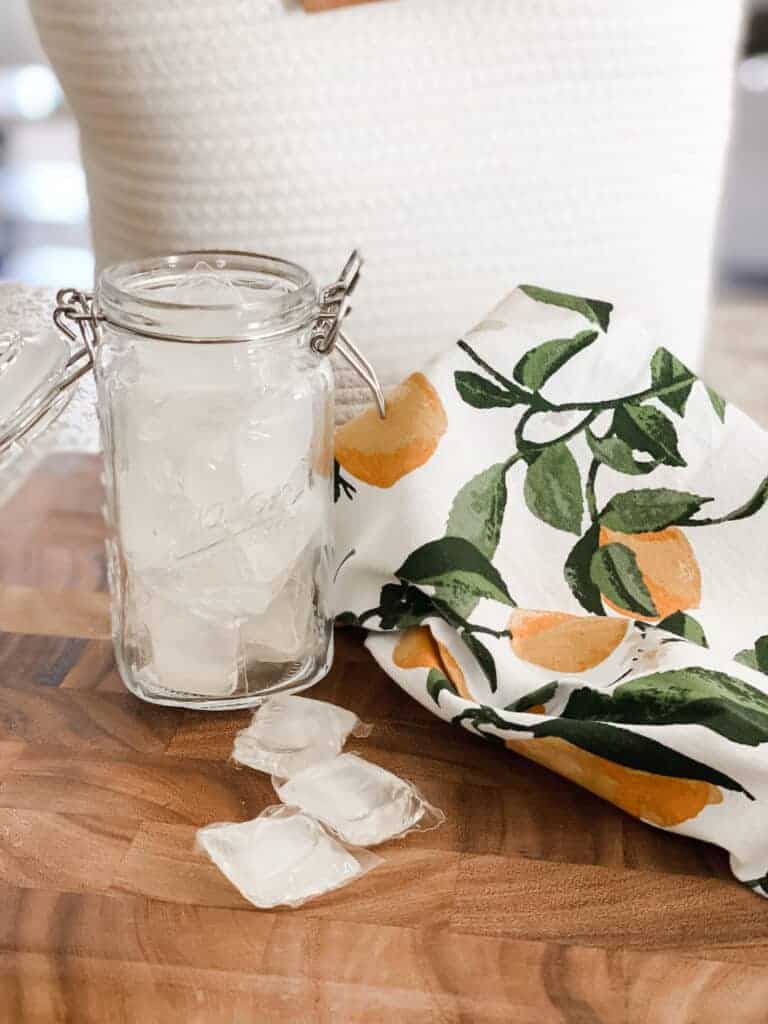natural cleaning laundry pods on wooden board with lemon tea towel 
