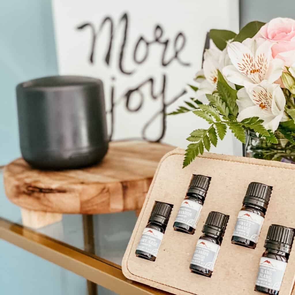 essential oil kit with flowers in background